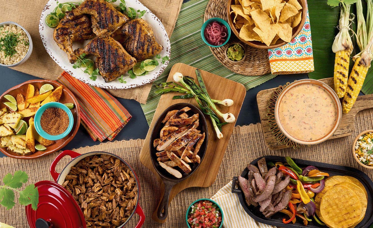 Mexican-style spread with grilled chicken, sliced steak fajitas, chips and salsa, corn, queso, rice